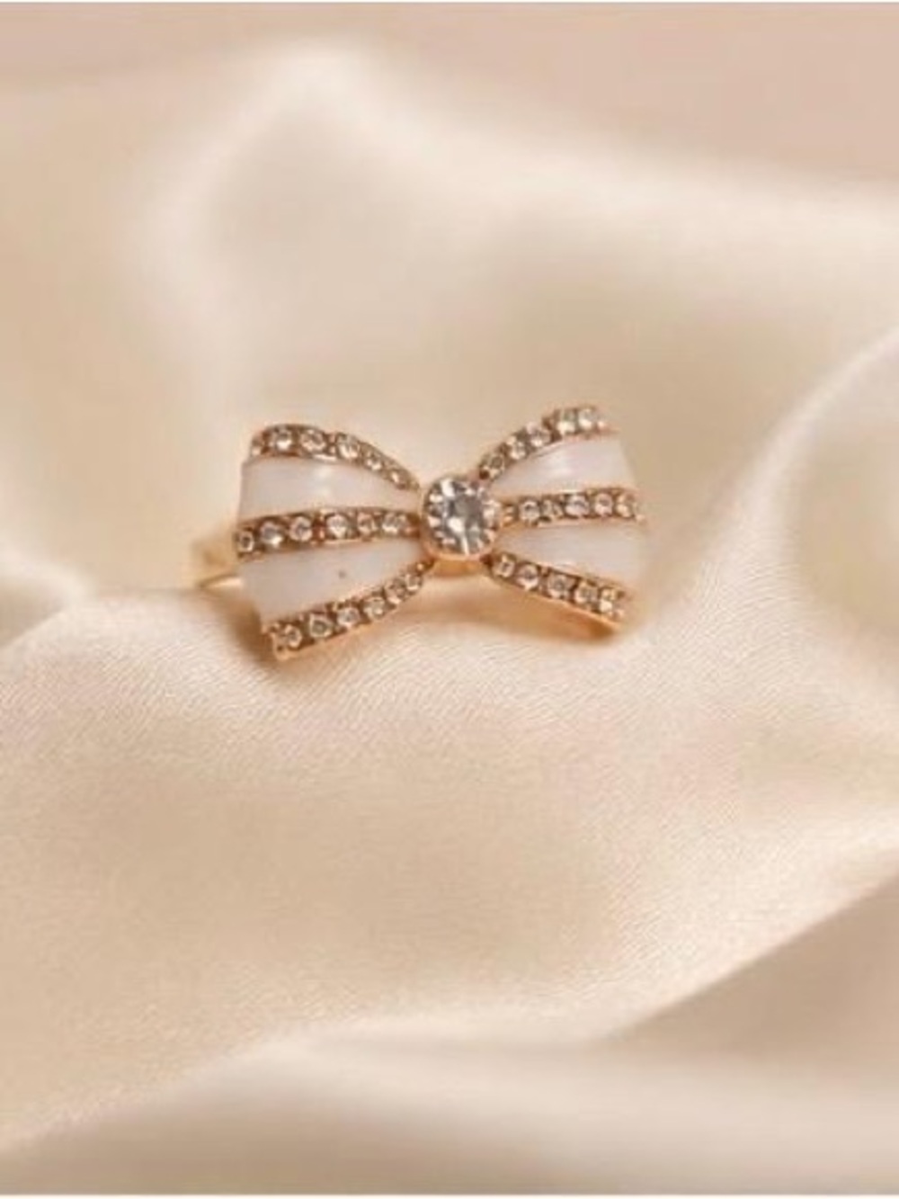 Anthropologie size 8 Gold Bow Ring with White Enamel and Crystal Center